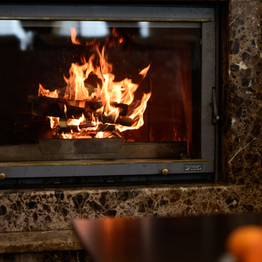 a burning fireplace in the lobby of the hotel, winter vacation in a warm hotel, a warm winter atmosphere