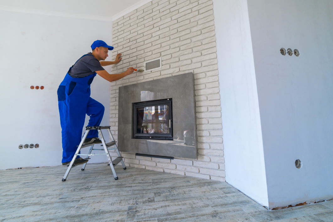 Fireplace installing in white brick wall<br />